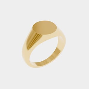 May include: A gold signet ring with a polished finish. The ring features a smooth, oval-shaped face and a rounded band. The ring is made of a shiny, yellow metal and is set against a white background.