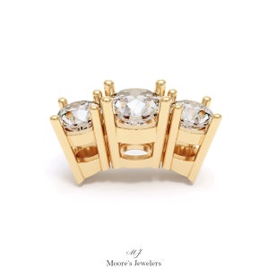 May include: A gold three-prong ring setting with three round diamonds. The setting is designed to hold three stones in a row.