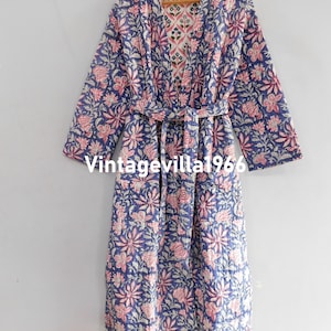 May include: A blue and pink floral patterned quilted robe with a matching tie belt. The robe has a V-neck and long sleeves.