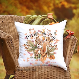 May include: White throw pillow with a cute cartoon squirrel holding an acorn surrounded by autumn leaves and the text "Happy Fall Y'all".