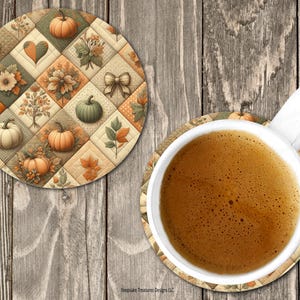 May include: Two round coasters with a fall theme. One coaster is under a white mug filled with coffee. The coasters feature a patchwork design with pumpkins, leaves, and floral elements in shades of orange, green, and cream.
