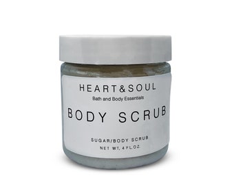 May include: A white jar with a black label that reads "HEART&SOUL Bath and Body Essentials BODY SCRUB SUGAR/BODY SCRUB NET WT, 4 FL.OZ."