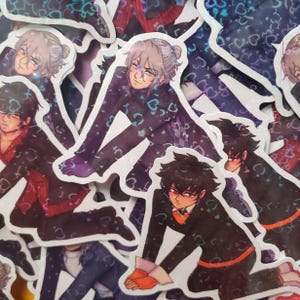 May include: A collection of anime-style stickers featuring male characters in various poses. The stickers have a glossy finish and are predominantly black, purple, and red, with heart-shaped patterns. The characters have different hairstyles and expressions.