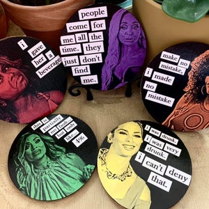 May include: Set of six round coasters featuring different women with humorous quotes. The quotes include "I gave her a beverage just don't find me", "This is partially my fault... but only like 4%", "I was drunk. I was very drunk. I can't deny that.", "Make no mistake, I made no mistake", "People come for me all the time. They just don't find me", and "I made no mistake".