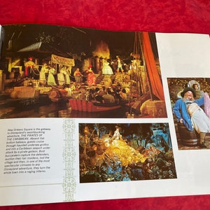 May include: A vintage book page with a photo of a pirate ship ride at Disneyland. The text on the page reads "New Orleans Square is the gateway to Disneyland's swashbuckling adventure, THE PIRATES OF THE CARIBBEAN. Aboard fat-bottom bateaux, guests cruise through haunted undersea grottos and into a Caribbean seaport under attack by a pirate galleon. Bold buccaneers capture the defenders, auction their fair maidens, loot the village and then, in one of the most spectacular climaxes to any Disneyland adventure, they turn the whole town into a raging inferno."