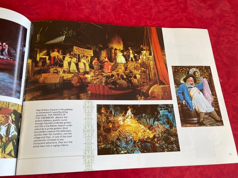 May include: A vintage book page with a photo of a pirate ship ride at Disneyland. The text on the page reads "New Orleans Square is the gateway to Disneyland's swashbuckling adventure, THE PIRATES OF THE CARIBBEAN. Aboard fat-bottom bateaux, guests cruise through haunted undersea grottos and into a Caribbean seaport under attack by a pirate galleon. Bold buccaneers capture the defenders, auction their fair maidens, loot the village and then, in one of the most spectacular climaxes to any Disneyland adventure, they turn the whole town into a raging inferno."