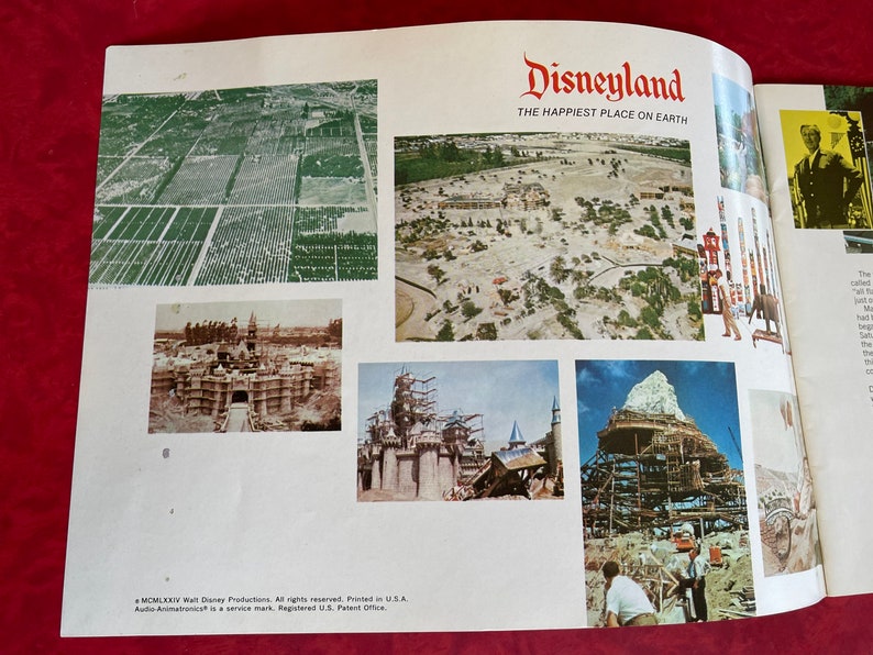 May include: A vintage brochure for Disneyland, featuring the text "Disneyland, The Happiest Place on Earth." The brochure shows aerial photos of the park under construction, including the iconic Sleeping Beauty Castle.