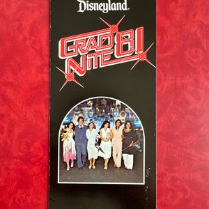 May include: A black and white brochure with the text "Disneyland Grad Nite 81" in red and white. The brochure features a group of people dressed in 1980s fashion, standing in front of a Disneyland attraction.