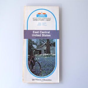 May include: A vintage Howard Johnson's Motor Lodge & Restaurant Directory/Map for the East Central United States. The cover features a scenic image of a building and a field of flowers. The text "The Flavor of America" is at the bottom.
