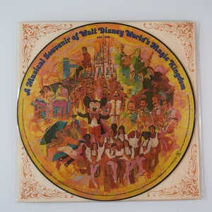 May include: A yellow vinyl record with a colorful illustration of Mickey Mouse and other Disney characters. The record is titled "A Musical Souvenir of Walt Disney World's Magic Kingdom".