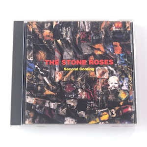 May include: A CD case featuring the album "Second Coming" by The Stone Roses. The cover art is a collage of images in various colors, with the band's name and album title in red text.