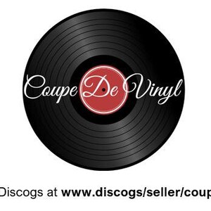 May include: A black vinyl record with the text "Coupe De Vinyl" in a cursive font. The center label is red with a white border. The image is on a white background.