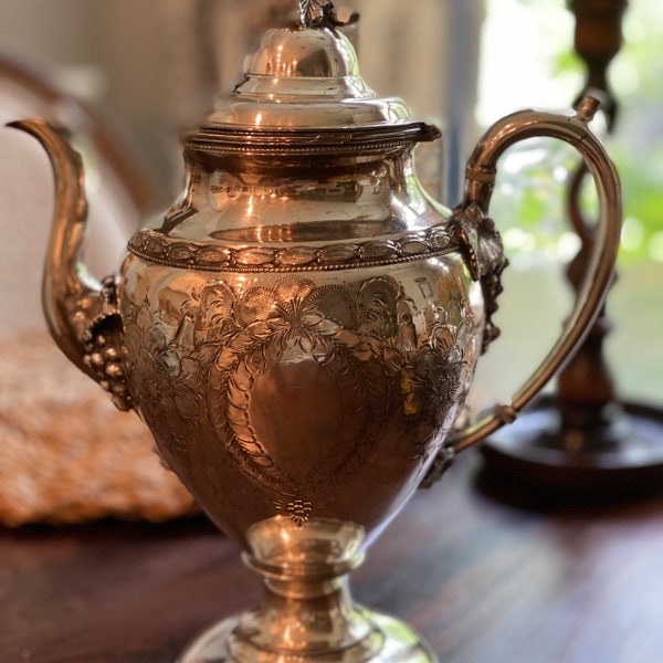 Silver Pitcher or Vase decorated with grape bunches and grape leaves.