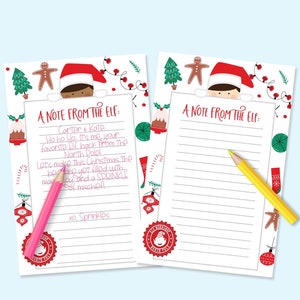 May include: Two Christmas-themed note pads with the text "A Note From The Elf." One pad has handwritten text and a pink pencil, the other has blank lines and a yellow pencil. Festive illustrations surround the notes.