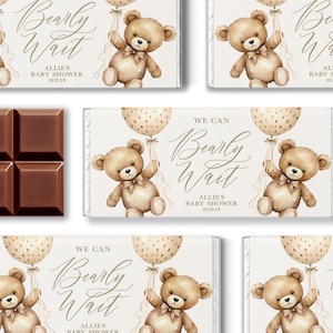 May include: Chocolate bars with a baby shower theme. Each bar features a watercolor teddy bear holding a balloon. The text "Bearly Wait" and "Allie's Baby Shower 10.19.24" are printed on the wrappers. A dark brown chocolate bar is also visible.