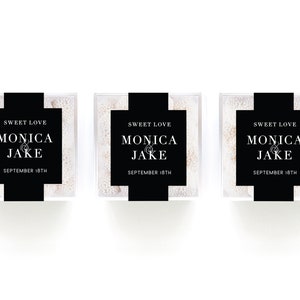 May include: Three clear boxes filled with white candy, each with a black label that reads "Sweet Love Monica & Jake September 18th".