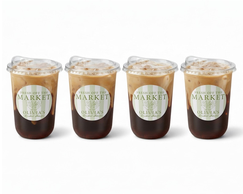 May include: Four iced coffee drinks in clear plastic cups with lids. Each cup has a sticker that reads "FRESH OFF THE MARKET" and "OLIVIA'S Bridal Shower". The coffee is layered with a dark brown base and a lighter, creamy top.