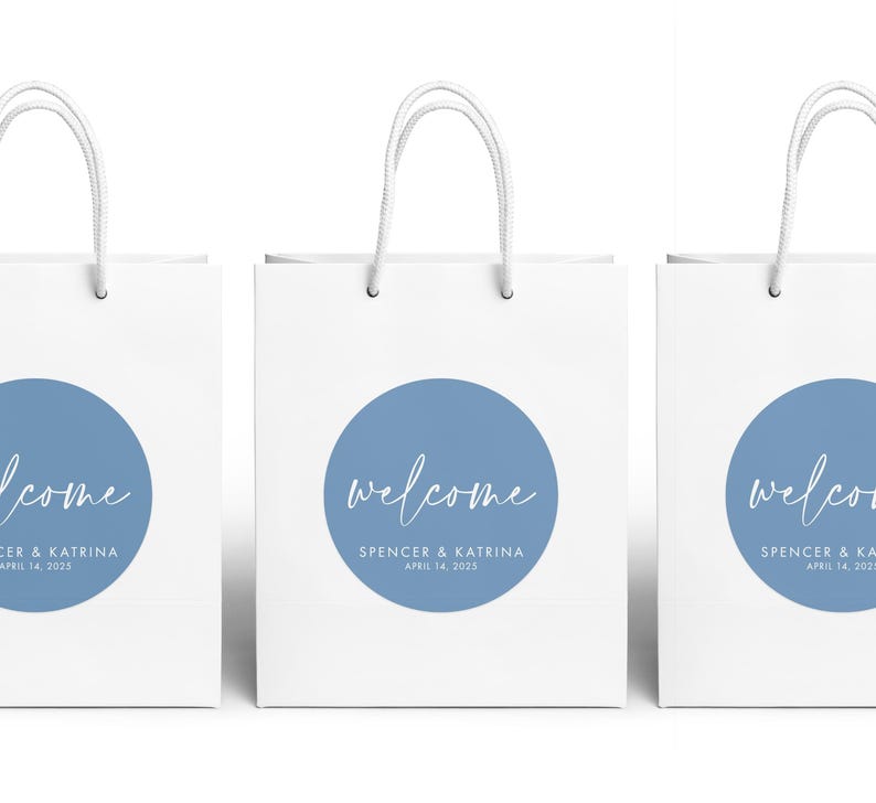 Three white paper bags with blue circular designs and the text "Welcome Spencer & Katrina April 14, 2020" printed on them.