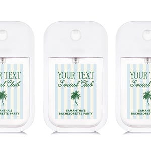 Three identical white spray bottles with text and graphics printed on them.