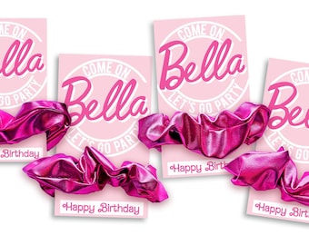 May include: Four metallic hot pink scrunchies displayed on individual light pink rectangular cards. Each card features a white circular graphic with the text Come on Bella Let's go party and the words Happy Birthday printed at the bottom.