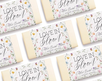 May include: A set of six white soap bars with floral designs and the text "Love in Bloom" and "Crettin's Bridal Shower August 26, 2029".