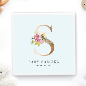May include: A light blue keepsake box with a gold floral letter S and the text "Baby Samuel Keepsake Box".