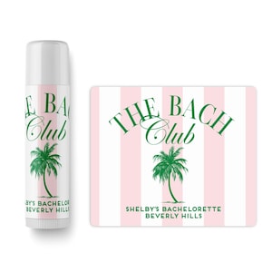 a bottle of lotion and a sticker with the text "The Bach Club" and a palm tree graphic.