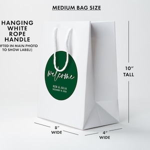 Medium white paper bag with a green welcome sign on it.