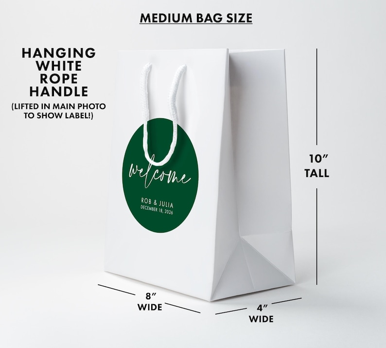 Medium white paper bag with a green welcome sign on it.
