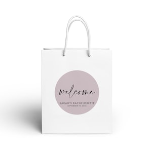 A white paper bag with a circular logo and text on it.