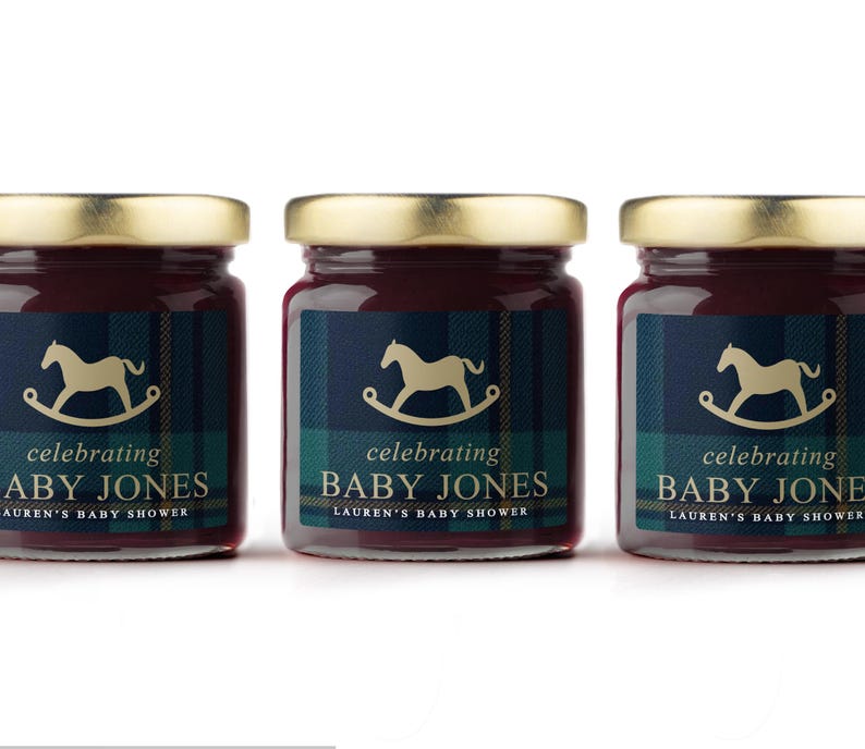 May include: Three small jars of jam with gold lids. Each jar has a label with a rocking horse graphic and the text "celebrating BABY JONES LAUREN'S BABY SHOWER". The labels have a navy and green plaid pattern.