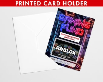 May include: A white envelope with a gaming-themed gift card. The card features the text "GAMING FUND" in neon colors, a Roblox logo, and the message "May your holidays be glitch-free." The card is from "Aunt Jaime."