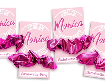 May include: Four bright pink metallic scrunchies attached to individual light pink rectangular cards. Each card features the white text "COME ON Monica LET'S GO PARTY" in a circular design and the words "Bachelorette Party" at the bottom.