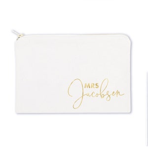 May include: White canvas zippered pouch with gold lettering that reads "MRS Jacobsen".