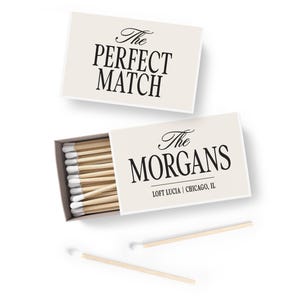 May include: Two matchboxes, one closed and one open, on a white background. The closed box reads "The PERFECT MATCH" in black script. The open box displays matches and reads "The MORGANS" and "LOFT LUCIA | CHICAGO, IL".