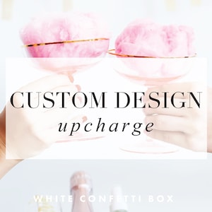 May include: Two pink champagne flutes with gold rims are held up by two hands. The text "CUSTOM DESIGN upcharge" is in the center of the image.