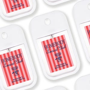 multiple identical white spray bottles with red and blue labels, each featuring the text "HOMEBODY Madison's Bachelorette" printed on them.