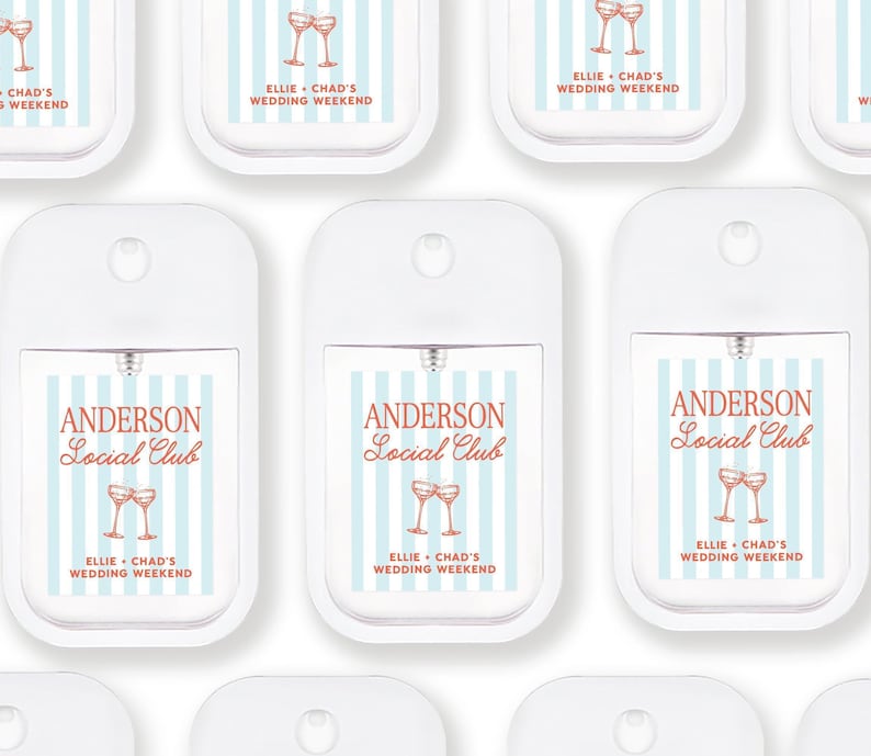 multiple identical white spray bottles with blue and orange stripes and text, arranged in a grid-like pattern.