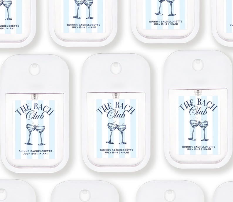 multiple white spray bottles with blue and white labels, each featuring a design of two champagne glasses and the text "The BACH Club" and "Quinn's Bachelorette July 15-18 Miami".