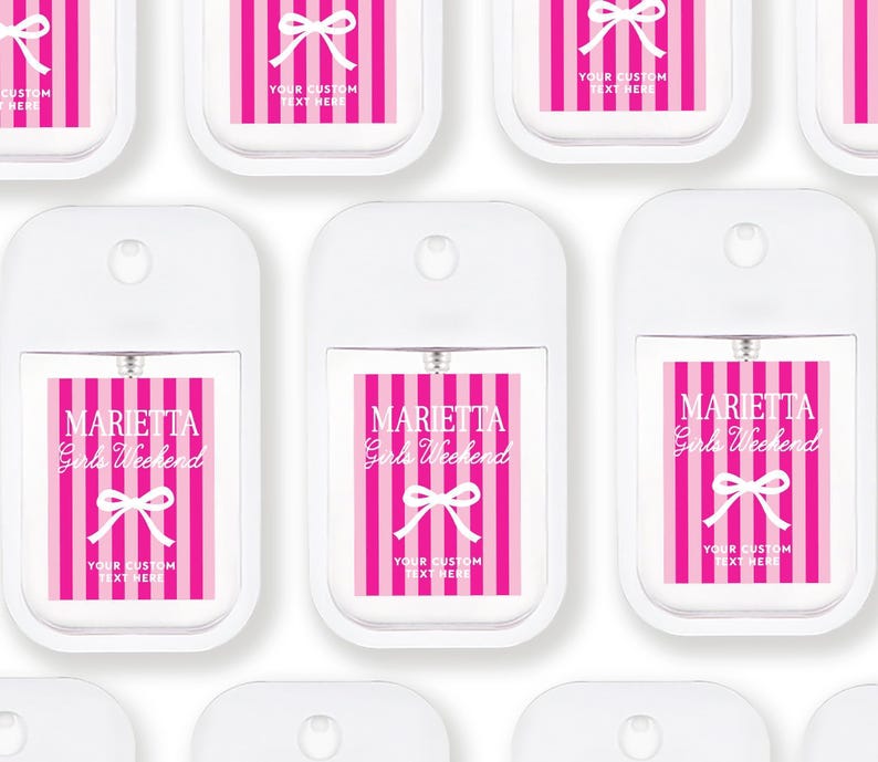 multiple white spray bottles with pink and white striped labels, each featuring the text "Maretta Girls Weekend" and "Your custom text here".
