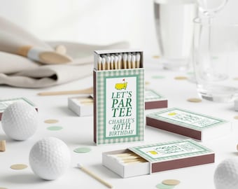 May include: A rectangular matchbox featuring a green and white gingham border, a yellow golf map graphic, and the text LET'S PAR TEE CHARLIE'S 40TH BIRTHDAY. The box is filled with wooden matches with white tips, surrounded by white golf balls.