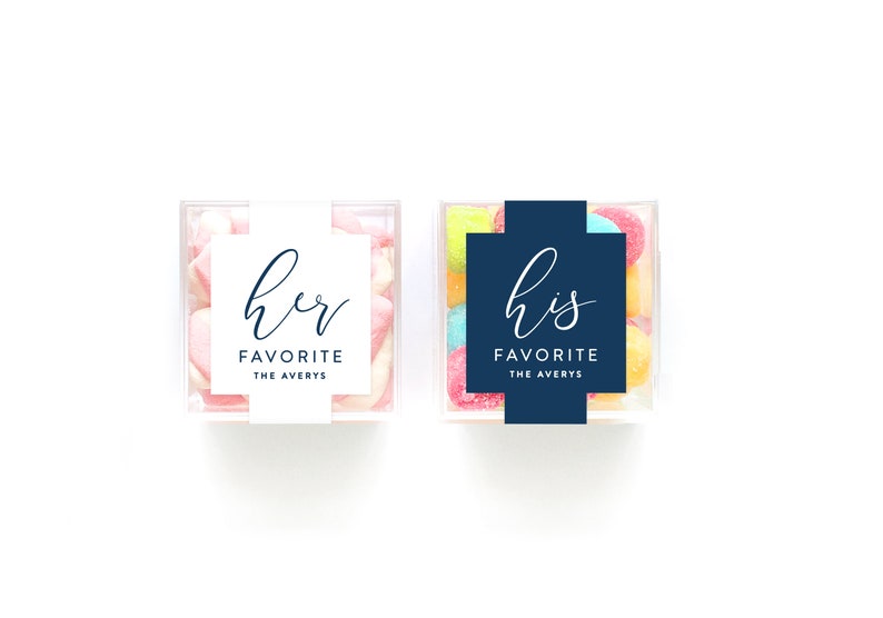 May include: Two clear plastic containers filled with candy. One container has pink and white candy with a white label that says "her favorite the averys". The other container has multi-colored candy with a navy blue label that says "his favorite the averys".