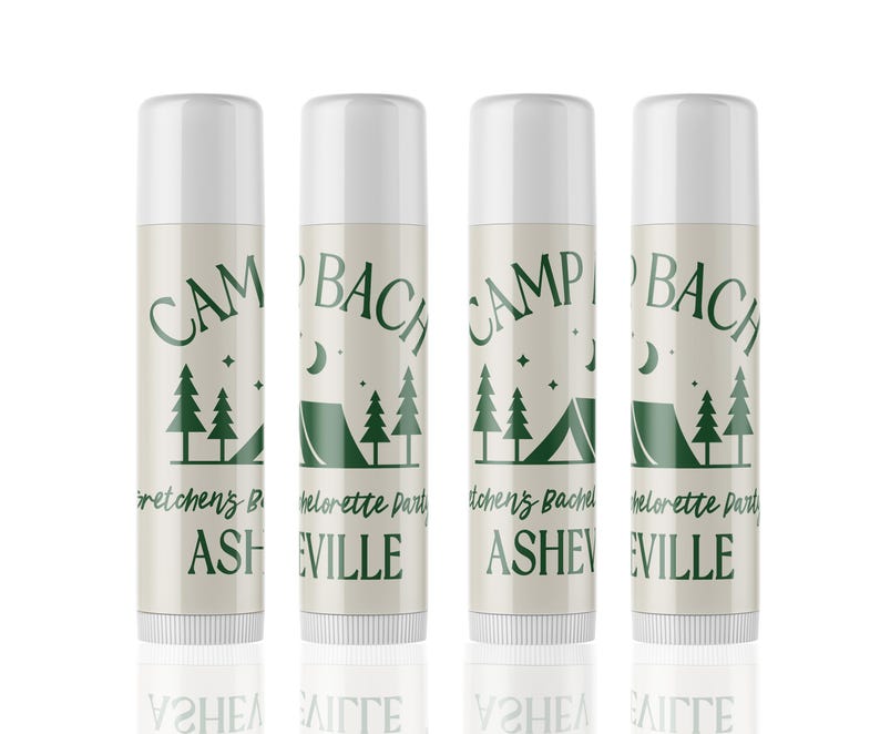 May include: Four white lip balm tubes with green text and graphics. The text reads "Camp Bachelorette Party" and "Camp Bachelor Party" with the location "Asheville" or "Eville".