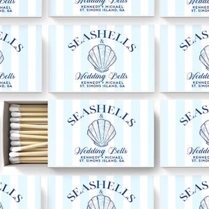 May include: A rectangular matchbox featuring a light blue and white vertical striped pattern. The front displays a dark blue illustration of a seashell above the text SEASHELLS & Wedding Bells KENNEDY + MICHAEL ST. SIMONS ISLAND, GA.