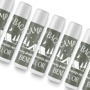 A row of identical camping-themed lip balms with the text "Camp Bend" printed on them.