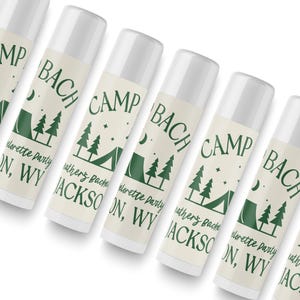 a row of identical tubes of lotion with a green and white label that reads "Camp Bach Jackson, WV".
