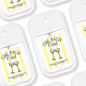multiple identical white hand sanitizer dispensers with a yellow and white striped design.