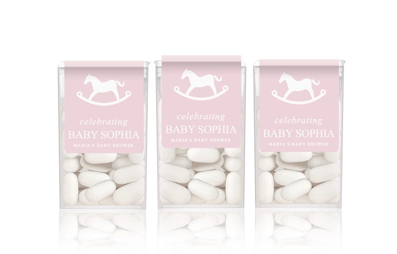 May include: Three pink and white favor boxes filled with white mints. Each box has a white rocking horse graphic and the text "celebrating Baby Sophia Maria's Baby Shower".
