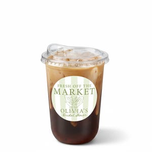 May include: A clear plastic cup filled with iced coffee, topped with a clear lid. A round sticker on the cup reads "FRESH OFF THE MARKET" and "OLIVIA'S Bridal Shower" in green text.