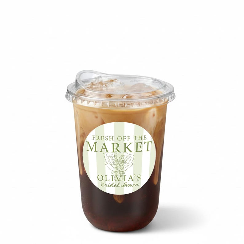 May include: A clear plastic cup filled with iced coffee, topped with a clear lid. A round sticker on the cup reads "FRESH OFF THE MARKET" and "OLIVIA'S Bridal Shower" in green text.
